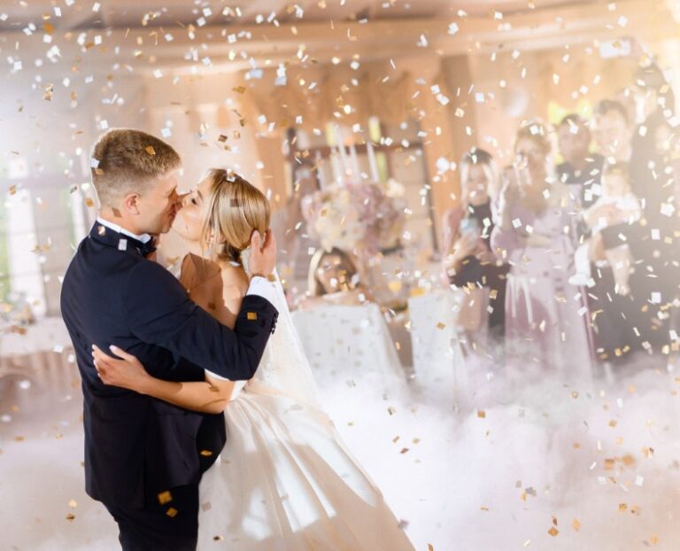 brides-kissing-hugging-while-falling-confettiCustom-768×622